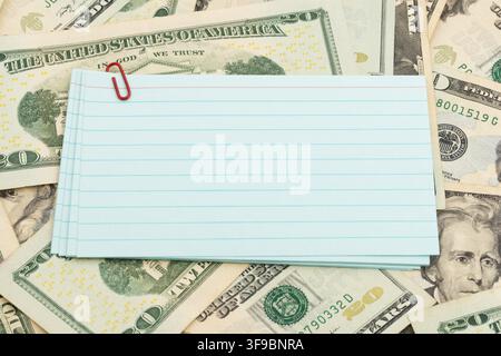 Blank lined index cards on twenty dollar bills for personal budget planning Stock Photo