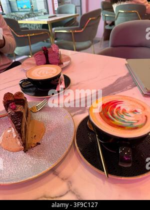 Delicious food selection with gourmet dishes, sweet desserts, fast food, and refreshing drinks served at a restaurant table. Stock Photo