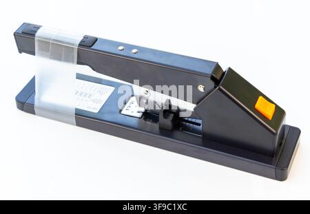 A black long reach stapler is isolated on a white background Stock Photo