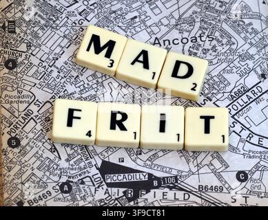 MadFrit Madchester-themed letter tiles over an Ancoats and Manchester street map, evoking Happy Mondays, the Hacienda and 1980s Mad Frit music Stock Photo