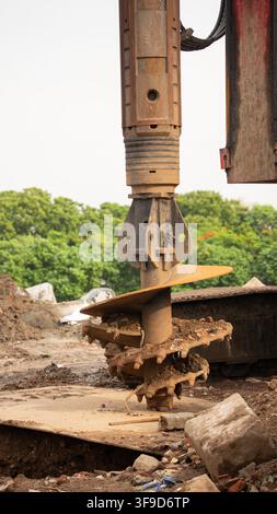 Hydraulic rock breaker attachment on an excavator at a demolition site Stock Photo