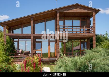 Modern Two Story Wooden Country House With Panoramic Windows and Garden Stock Photo
