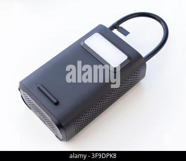 A black portable electronic device with a bright light on a white background Stock Photo