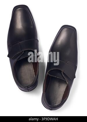 pair of black leather dress shoes isolated white background, shiny formal footwear with velcro straps, top view with shadow Stock Photo