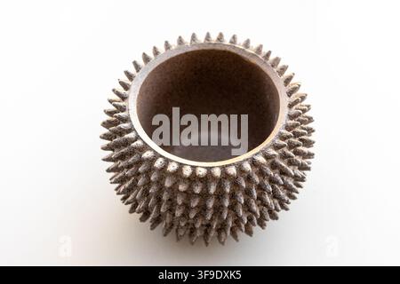 A unique rough textured bowl sits on a plain white background Stock Photo