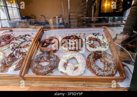 Chocolate glazed pretzels with colorful sprinkles Stock Photo