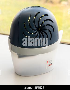 A white and blue moisture absorber sits on a white surface Stock Photo