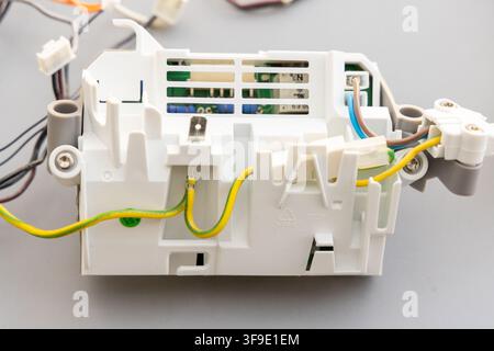 A white plastic electronic module with wires and a circuit board Stock Photo