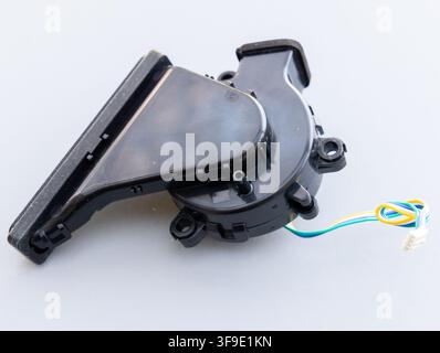 A black plastic centrifugal fan with wires lies on a white surface Stock Photo