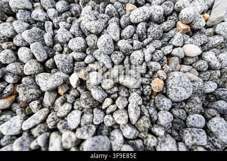 Bed of Smooth Pebbles and Natural Stones with Light Gray Texture, Full Frame Stone Surface Background for Architecture and Design Stock Photo