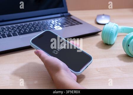 Hand holding an iPhone with the Kling AI app logo. Stock Photo