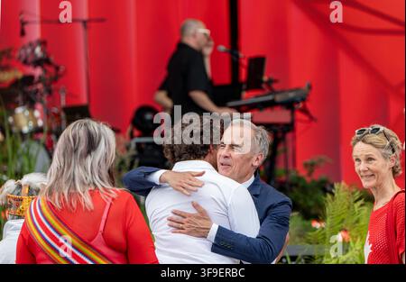 Canadian Prime Minister Mark Carney embraces former Prime Minister Justin Trudeau at the conclusion of the main stage noon ceremony. Stock Photo