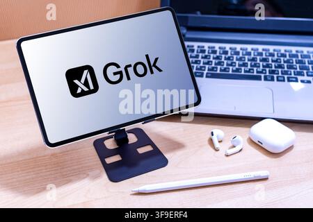 Grok AI logo on an Apple iPad screen. Stock Photo