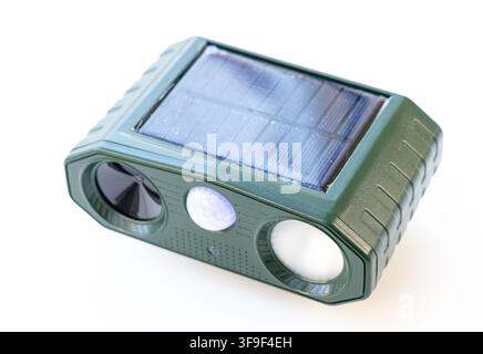 A green solar powered ultrasonic pest repellent is shown on white Stock Photo