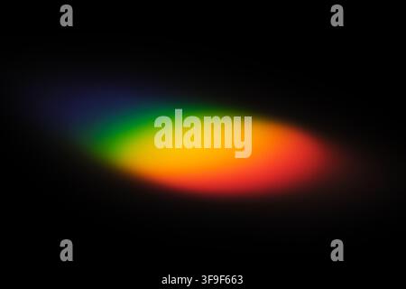 Abstract rainbow light refraction on black background Stock Photo