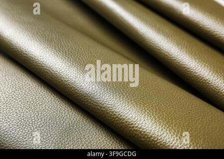 Olive green textured leather fabric with natural folds and creases, material background for fashion and upholstery Stock Photo