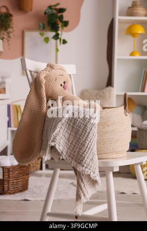 Plush pink bunny in woven basket, vibrant flowers, delicate petals ...