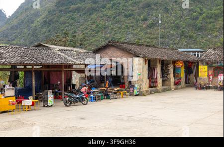Dinh thu Vua Meo, Vietnam - October 11, 2023: Local people operating traditional market stalls in Ha Giang province Stock Photo