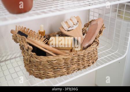 Basket with grooming tools on a white shelf Stock Photo