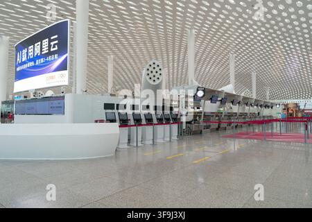 Shenzhen, China - August 04, 2026: Check-in counters and self-service kiosks inside Shenzhen Bao'an International Airport. Stock Photo