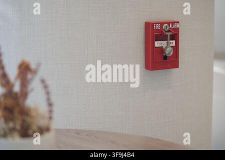 Fire alarm on wall near table in a modern room Stock Photo