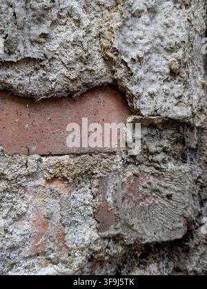 Weathered brick wall no action present, in outdoor urban environment, with brick, mortar, from a close-up perspective perspective, with gray, brown ac Stock Photo