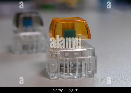 Macro Close Up of Mechanical Keyboard Switch with Orange Keycap, Custom Keyboard Component Stock Photo