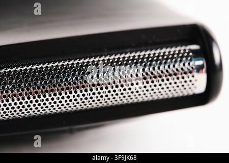 Macro extreme close up electric razor foil head showcasing metallic mesh texture Stock Photo