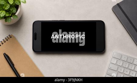 In this photo illustration, a horizontally placed smartphone displays the Anthropic AI app logo on a minimalist office desk, in Guwahati, India on 13 August 2026. Stock Photo