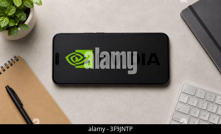 In this photo illustration, a horizontally placed smartphone displays the Nvidia logo on a minimalist office desk, in Guwahati, India on 13 August 2026. Stock Photo