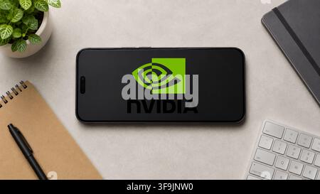 In this photo illustration, a horizontally placed smartphone displays the Nvidia logo on a minimalist office desk, in Guwahati, India on 13 August 2026. Stock Photo