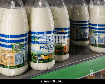 Kyiv, Ukraine - March 14, 2026: Rows of Prostokvashino milk in plastic bottles displayed on a grocery rack, showcasing consumer goods availability for Stock Photo