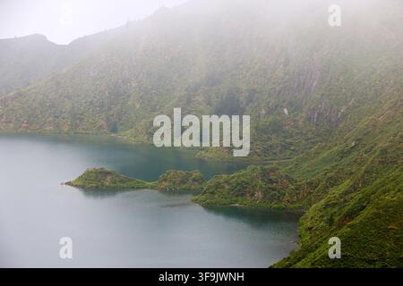 Fire Lake- Lagoa do Fogo-appears in the inner caldera of the Água de Pau volcano, emerging from the fog, Sao Miguel, Azores, Portugal Stock Photo