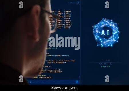Close-up from behind of software engineer working with AI assistant, programming on a large monitor, Artificial intelligence agent writing code, helping with software development. Copy space Stock Photo