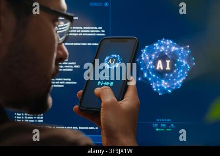 Rear view close-up of man holding smartphone and talking with AI voice assistant app with futuristic artificial intelligence chatbot or AI agent interface in the background. Space for text  Stock Photo