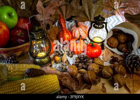 Seasonal arrangement showing pumpkins, lanterns, corn, fruits, and nuts celebrating thanksgiving Stock Photo