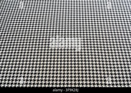 Black and white houndstooth textile pattern with fine woven texture and repeating geometric design, seamless fashion fabric background Stock Photo