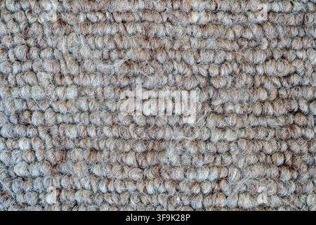 Close-up of textured beige and brown boucle fabric with soft natural fibers and a cozy woven surface, abstract textile background for interior design Stock Photo
