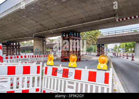 Heavy steel structures secure the damaged bridge in Dresden against collapse. Construction barriers and warning lights stand below. Stock Photo