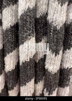 Close up of black white and gray knitted textile texture creating abstract cozy background for fashion design, fabric, packaging, wallpaper Stock Photo