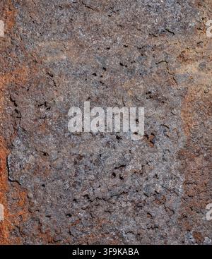 Detailed full-frame background image showcasing intricate texture of rusted metal. Surface features coarse, pitted appearance with visible cracks and Stock Photo