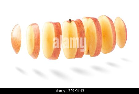 Flying Slices of Fresh Red Apple Flying in Air Stock Photo