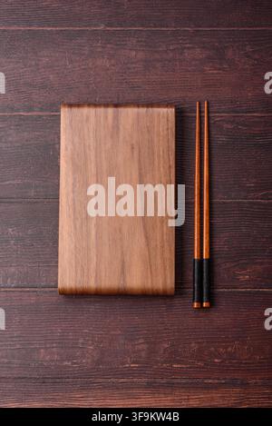 A square wooden cutting board for home food preparation. A wooden cutting board serving as a food background for your design Stock Photo