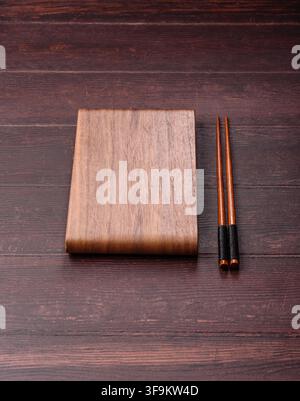 A square wooden cutting board for home food preparation. A wooden cutting board serving as a food background for your design Stock Photo