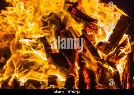 Close-Up Of Intense Wood Fire Flames And Burning Logs In Hot Orange Bonfire Stock Photo