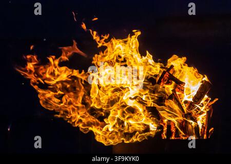 Close-Up Of Intense Wood Fire Flames And Burning Logs In Hot Orange Bonfire Stock Photo