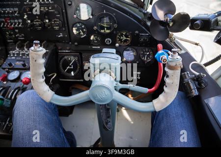 Close-up of vintage aircraft control panel label showing intercom and radio switch markings with serial number, aviation instrument detail Stock Photo