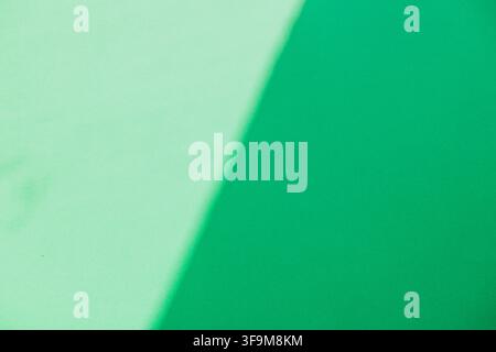 Minimalist abstract geometric background with soft diagonal shadow on light mint and vibrant green paper surface. Modern clean backdrop template with Stock Photo
