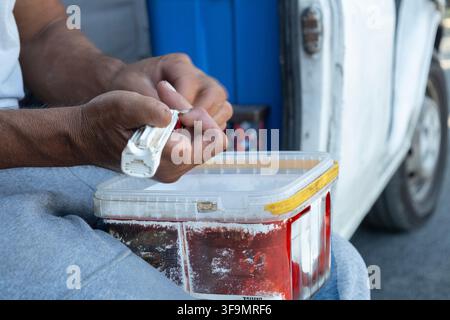 Worker hands using tools at a construction site Stock Photo