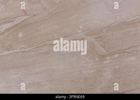 Detailed surface of light brown marble with pale diagonal veins and speckled mineral inclusions, photographed flat as a seamless natural stone backgro Stock Photo